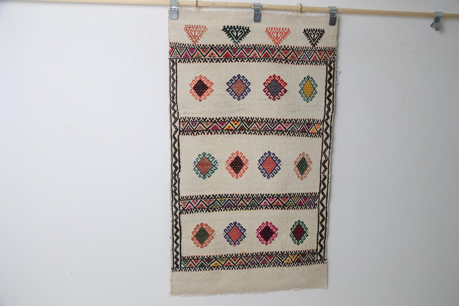 Beige kilim rug close-up, woven tribal motif