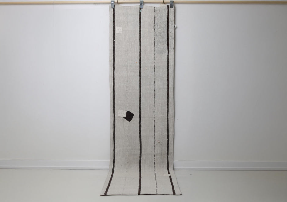2'2 x 7'10 vintage Turkish hemp runner rug hanging showing white field with thin black vertical stripes