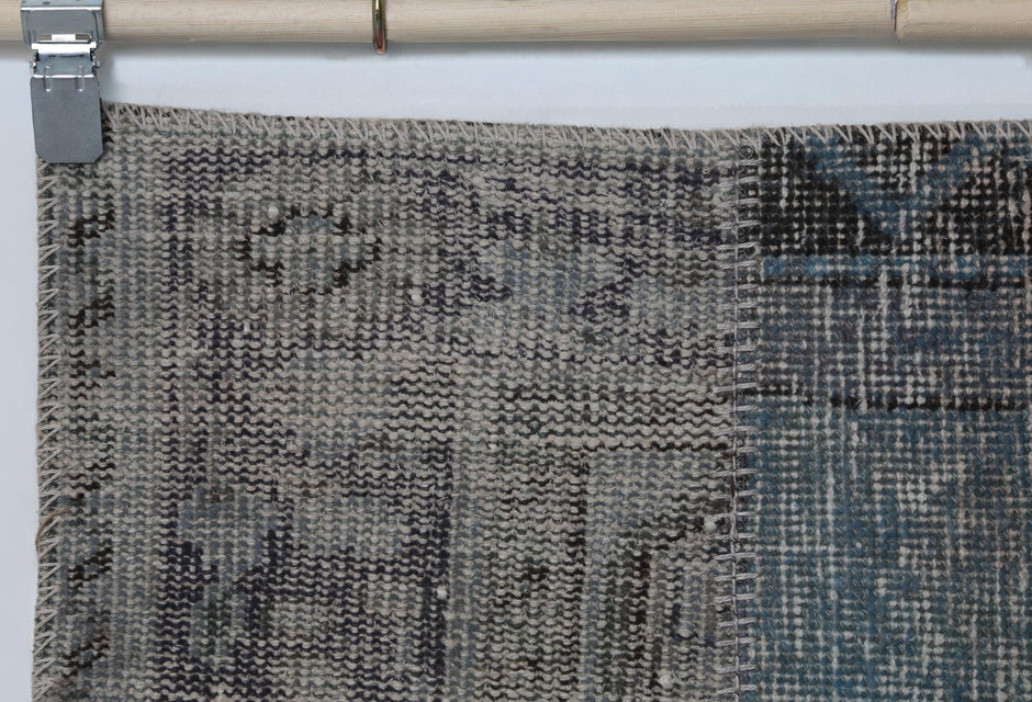 Full vintage patchwork runner rug hanging showing narrow hallway rug in blue gray tones