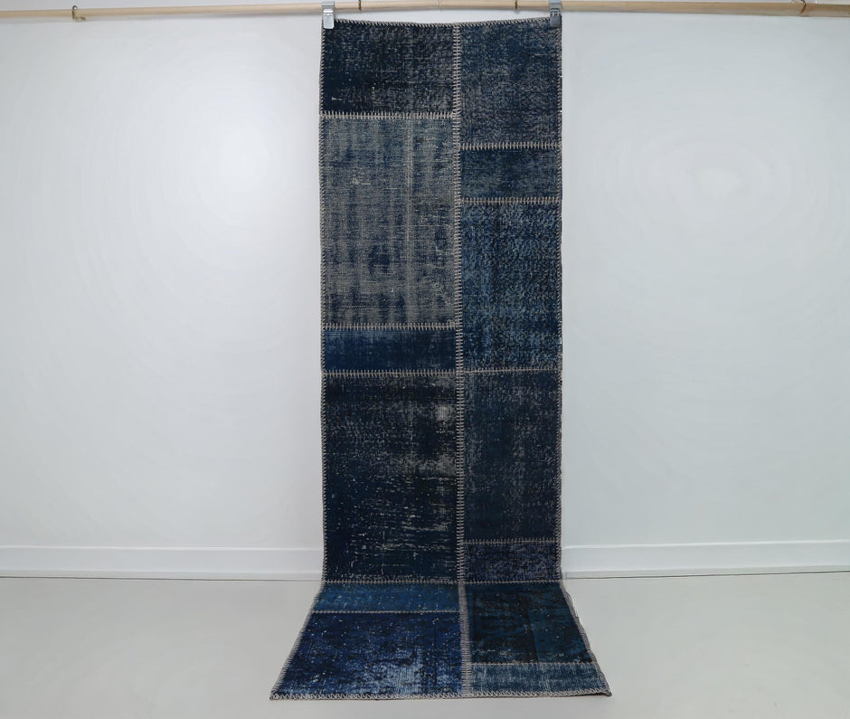2x8 vintage patchwork runner rug hanging showing rich indigo blue panel design