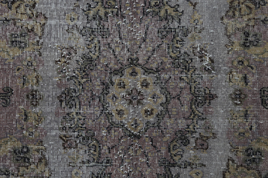 Vintage gray pink oriental rug displayed in classic hallway