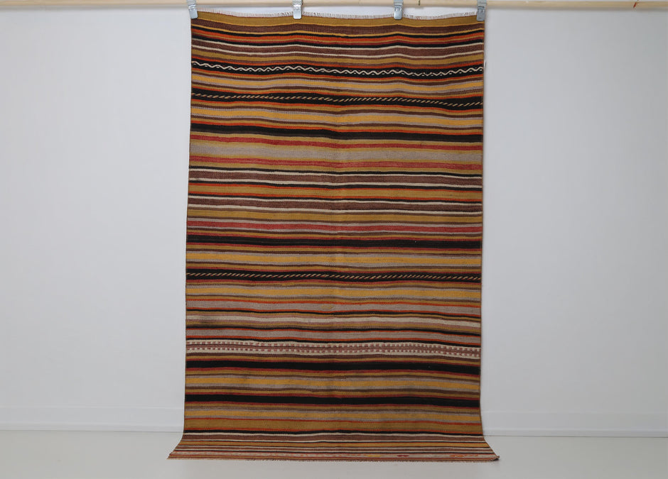4x6 vintage Turkish kilim rug hanging showing full multicolor horizontal striped pattern
