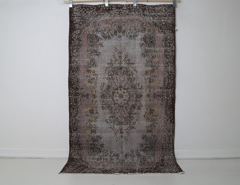 Close-up of floral detail on gray pink oriental rug