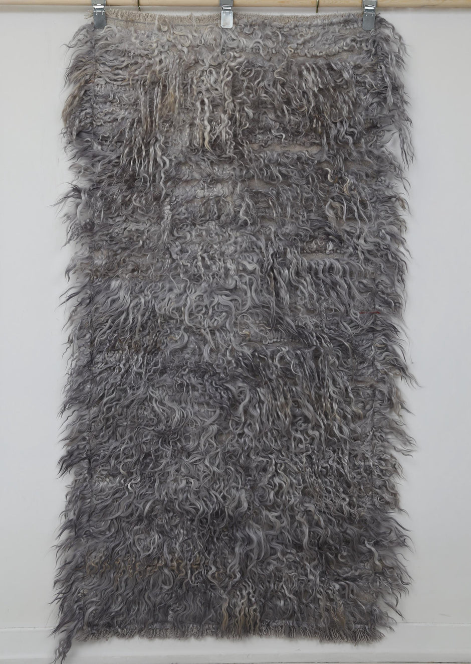 Close-up of long pile wool texture on gray tulu runner rug