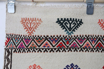 Full rug display, beige field, patterned accents