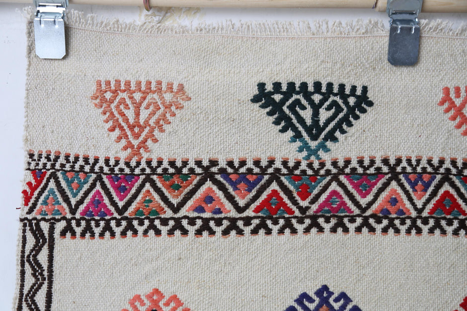 Full rug display, beige field, patterned accents