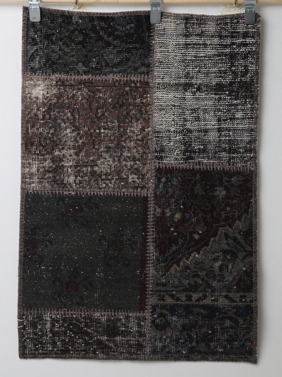 Black brown patchwork doormat close-up, weave texture detail