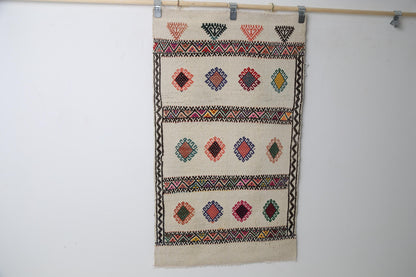 Beige kilim rug close-up, woven tribal motif