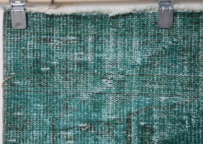 Full vintage Turkish runner rug hanging showing long teal green hallway rug design