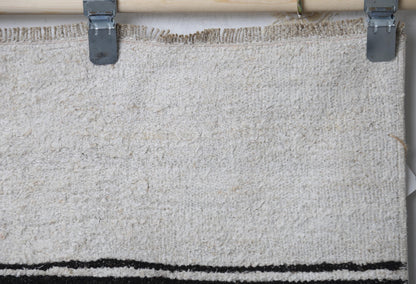 Full vintage hemp runner rug hanging showing minimal white and black striped hallway rug