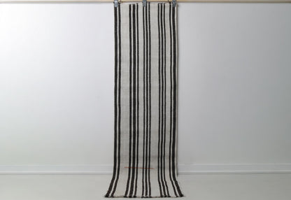 2'0 x 7'7 vintage Turkish hemp runner rug hanging showing white field with black vertical stripes