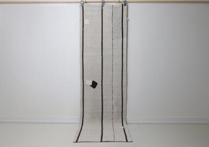 2'2 x 7'10 vintage Turkish hemp runner rug hanging showing white field with thin black vertical stripes