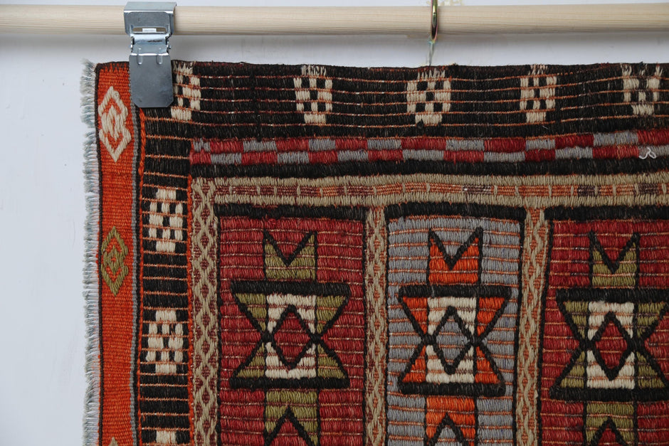 Geometric oriental motifs close-up, red kilim doormat