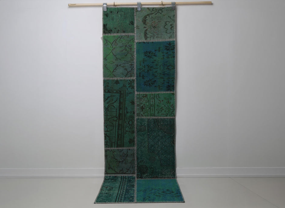 2'5 x 7'8 vintage Turkish patchwork runner rug hanging showing rich emerald green overdyed pattern