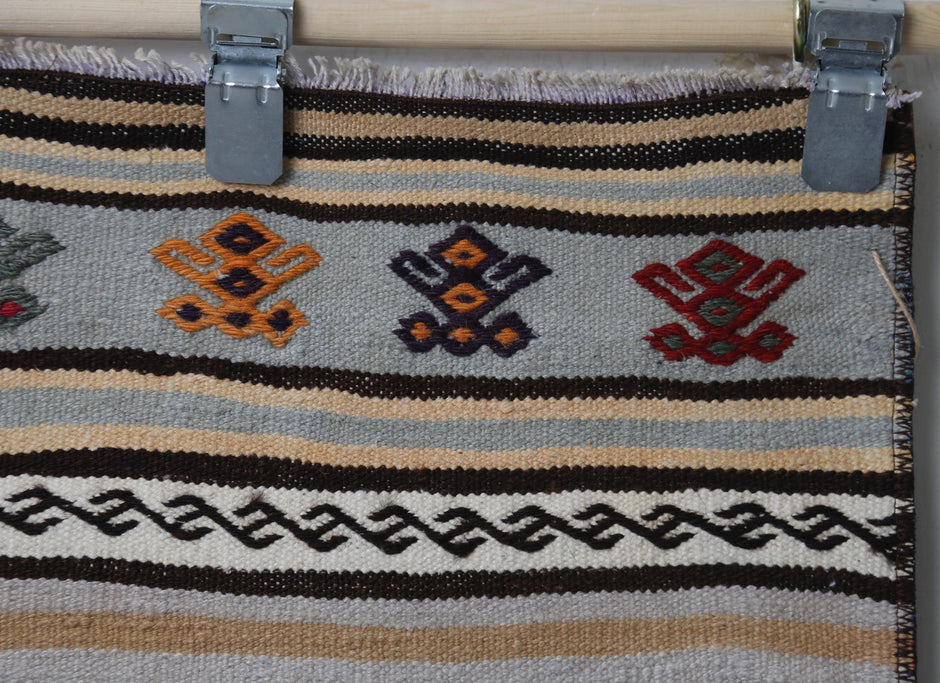 Side perspective, pattern arrangement, striped kilim runner