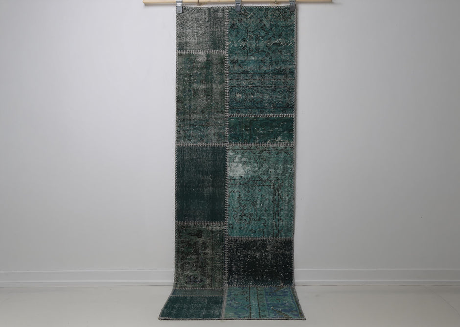 2'5 x 7'7 vintage Turkish patchwork runner rug hanging showing deep teal green overdyed panel design