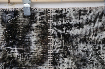 Detail shot of vintage Turkish patchwork rug panel showing charcoal and brown speckled texture