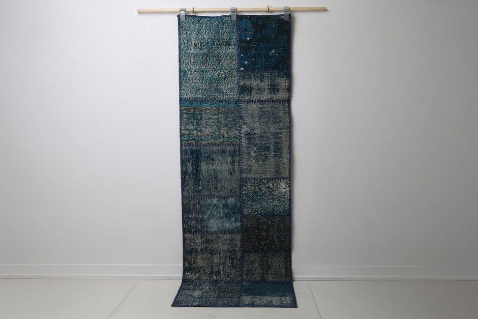 2'5 x 7'2 vintage Turkish patchwork runner rug hanging showing rich teal blue overdyed pattern