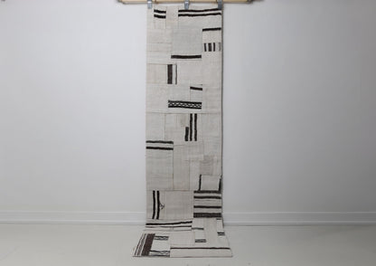 1'11 x 7'10 vintage Turkish hemp patchwork runner rug hanging showing white field with black minimal marks