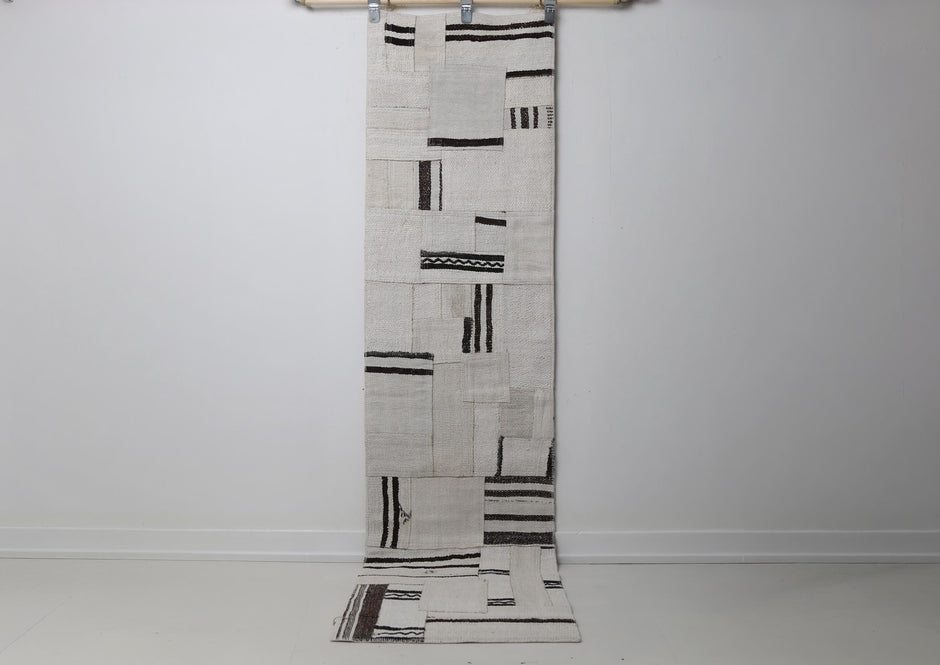 1'11 x 7'10 vintage Turkish hemp patchwork runner rug hanging showing white field with black minimal marks