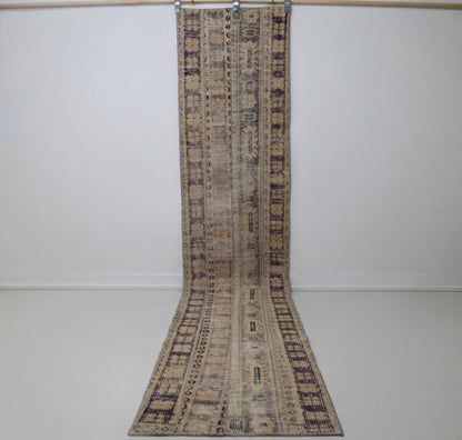1'11 x 10'9 vintage Turkish runner rug hanging showing long beige brown patchwork design