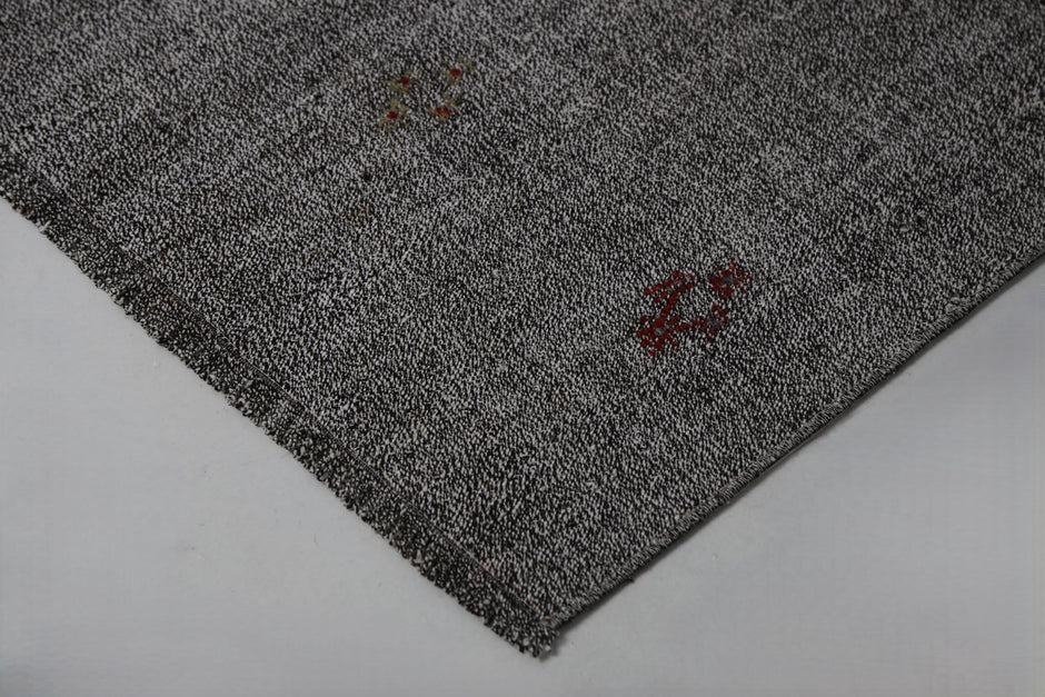 Black white flatweave rug close-up, striped pattern weave texture