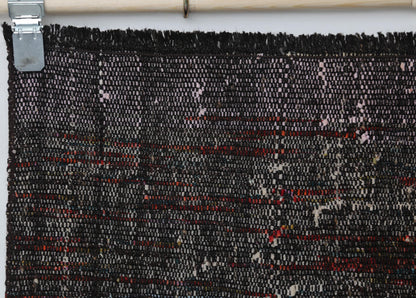 Full vintage flatweave runner rug hanging showing black red hallway rug design