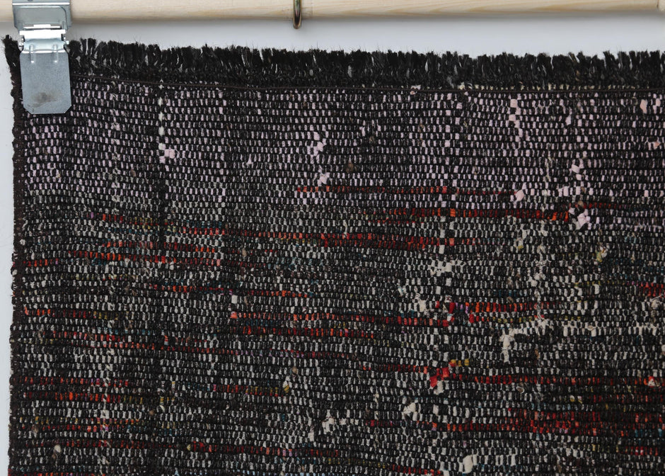 Full vintage flatweave runner rug hanging showing black red hallway rug design
