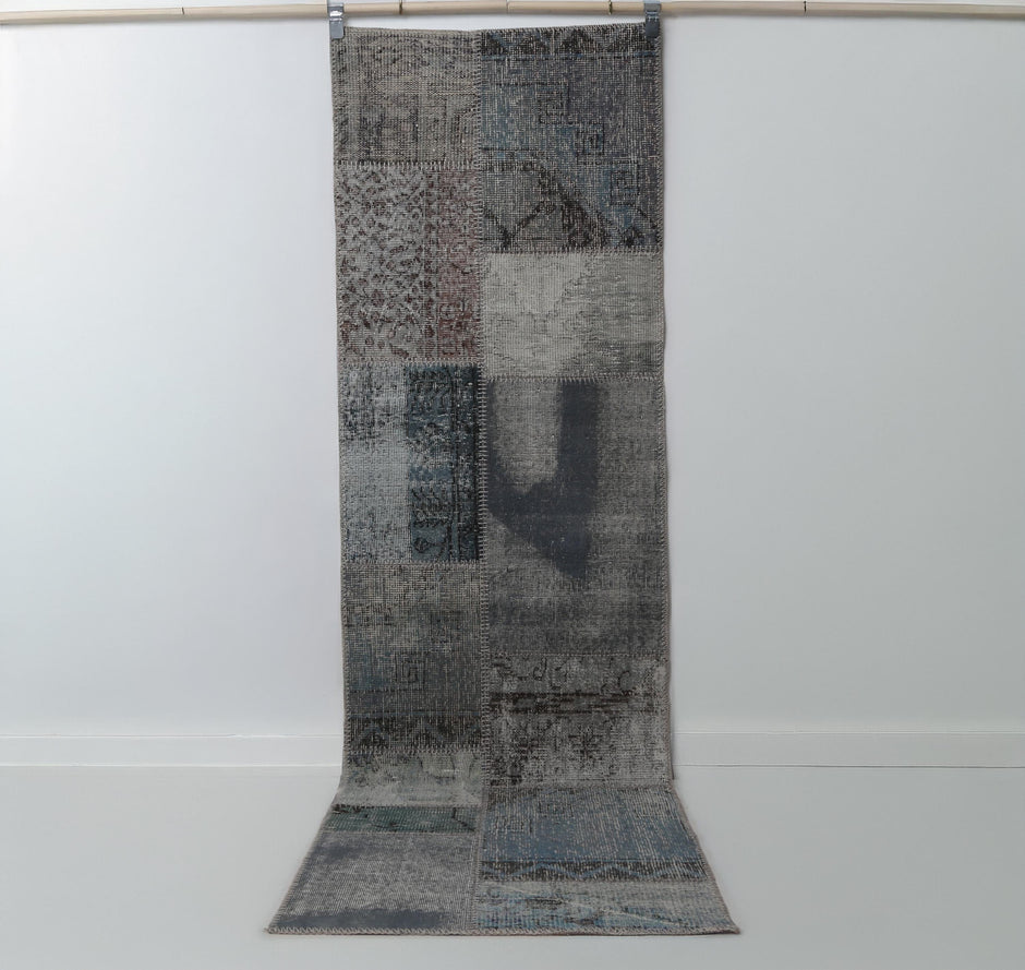 2x8 vintage patchwork runner rug hanging showing blue toned distressed panel design