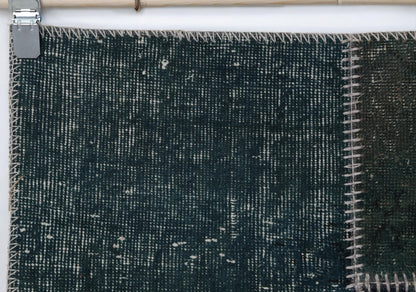 Full vintage patchwork runner rug hanging showing long green narrow hallway rug