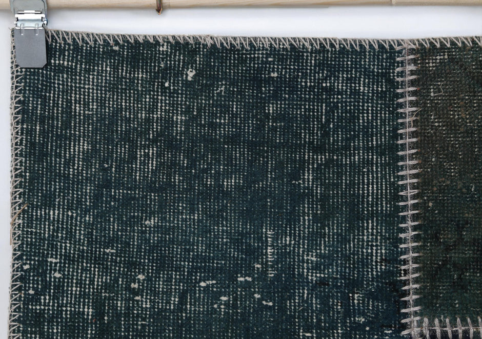Full vintage patchwork runner rug hanging showing long green narrow hallway rug