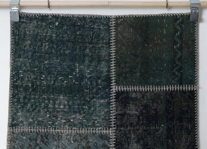 Detail shot of vintage Turkish patchwork rug panel showing rich green overdyed texture