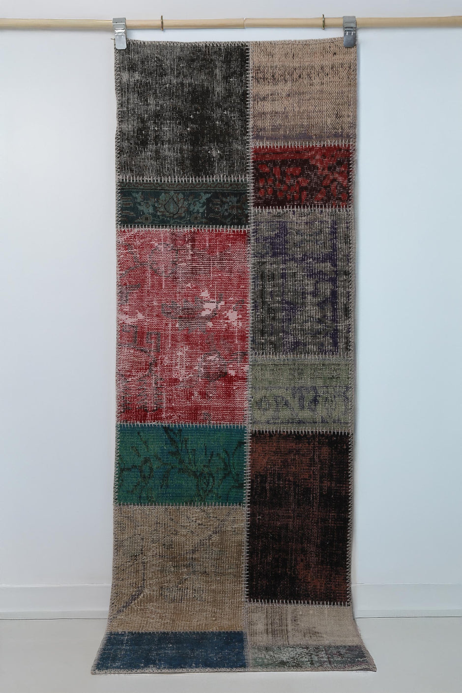 Close-up of vintage Turkish runner rug texture showing dark distressed black panel weave
