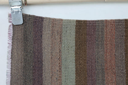 Full vintage Turkish kilim runner hanging showing narrow striped hallway rug design