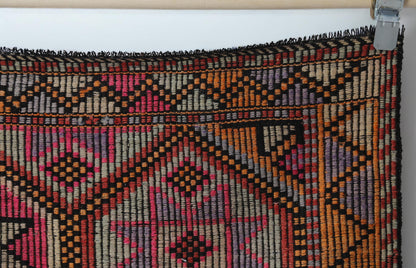 Vintage oriental flatweave rug detail showing large geometric octagon pattern in red and black