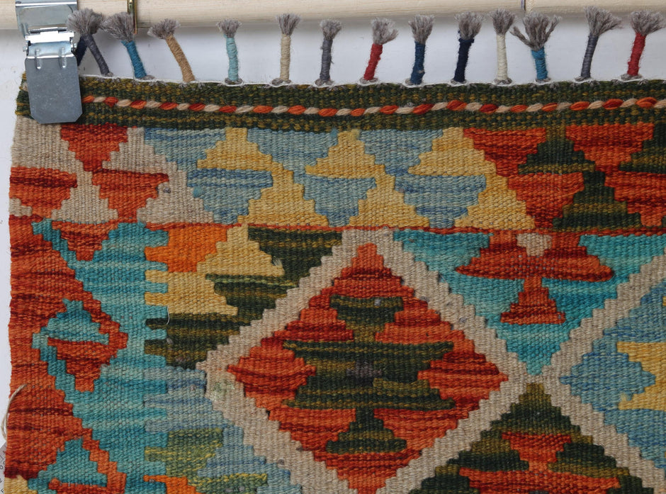Vintage oriental flatweave accent rug detail showing colorful diamond medallion pattern