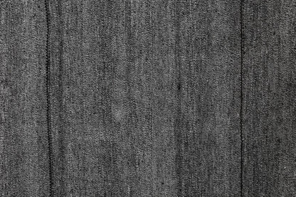 Close-up of handmade kilim rug edge showing fine striped flatweave texture