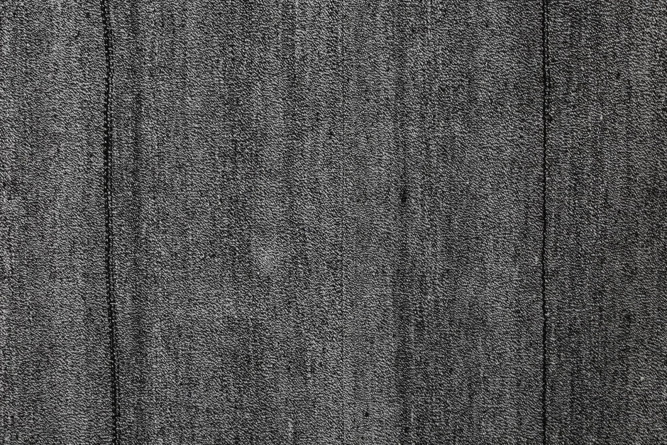 Close-up of handmade kilim rug edge showing fine striped flatweave texture