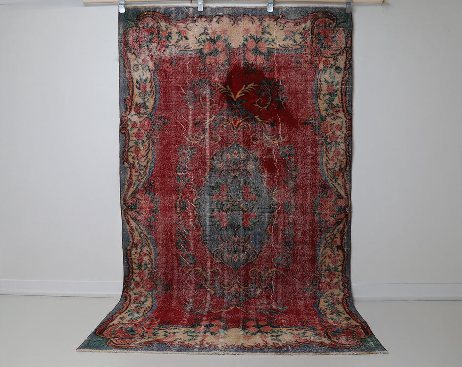 Close-up of medallion border detail on red beige oriental rug