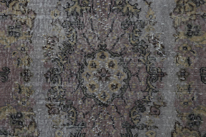Vintage gray pink oriental rug displayed in classic hallway