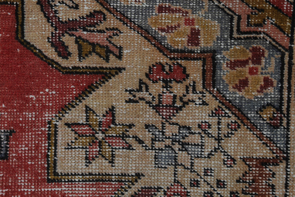 Back side of handmade red beige and brown oriental rug showing weave texture