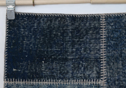 Full vintage patchwork runner rug hanging showing dark indigo blue narrow hallway rug