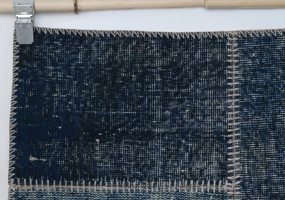 Full vintage patchwork runner rug hanging showing dark indigo blue narrow hallway rug