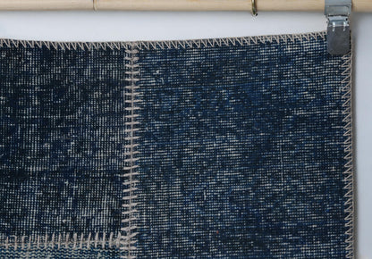 Close-up of handmade wool cotton runner rug showing rich blue distressed weave texture