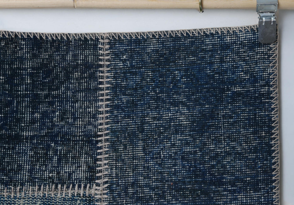 Close-up of handmade wool cotton runner rug showing rich blue distressed weave texture