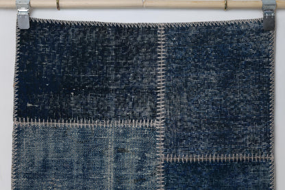  Detail shot of vintage Turkish patchwork rug panel showing deep indigo blue distressed texture