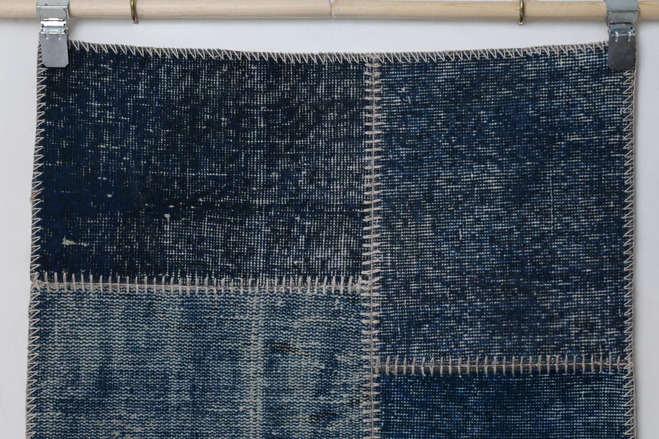  Detail shot of vintage Turkish patchwork rug panel showing deep indigo blue distressed texture