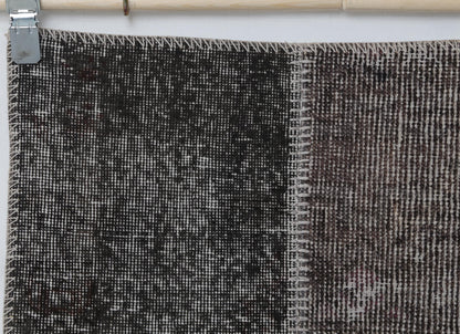 Full vintage patchwork runner rug hanging showing narrow hallway rug in gray brown tones