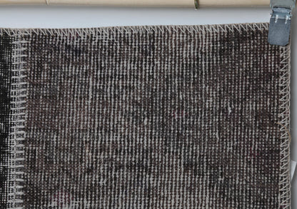 Close-up of handmade wool cotton runner rug showing distressed gray brown weave texture