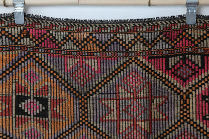 Close-up of handmade wool cotton kilim rug showing dense oriental lattice pattern in warm tones